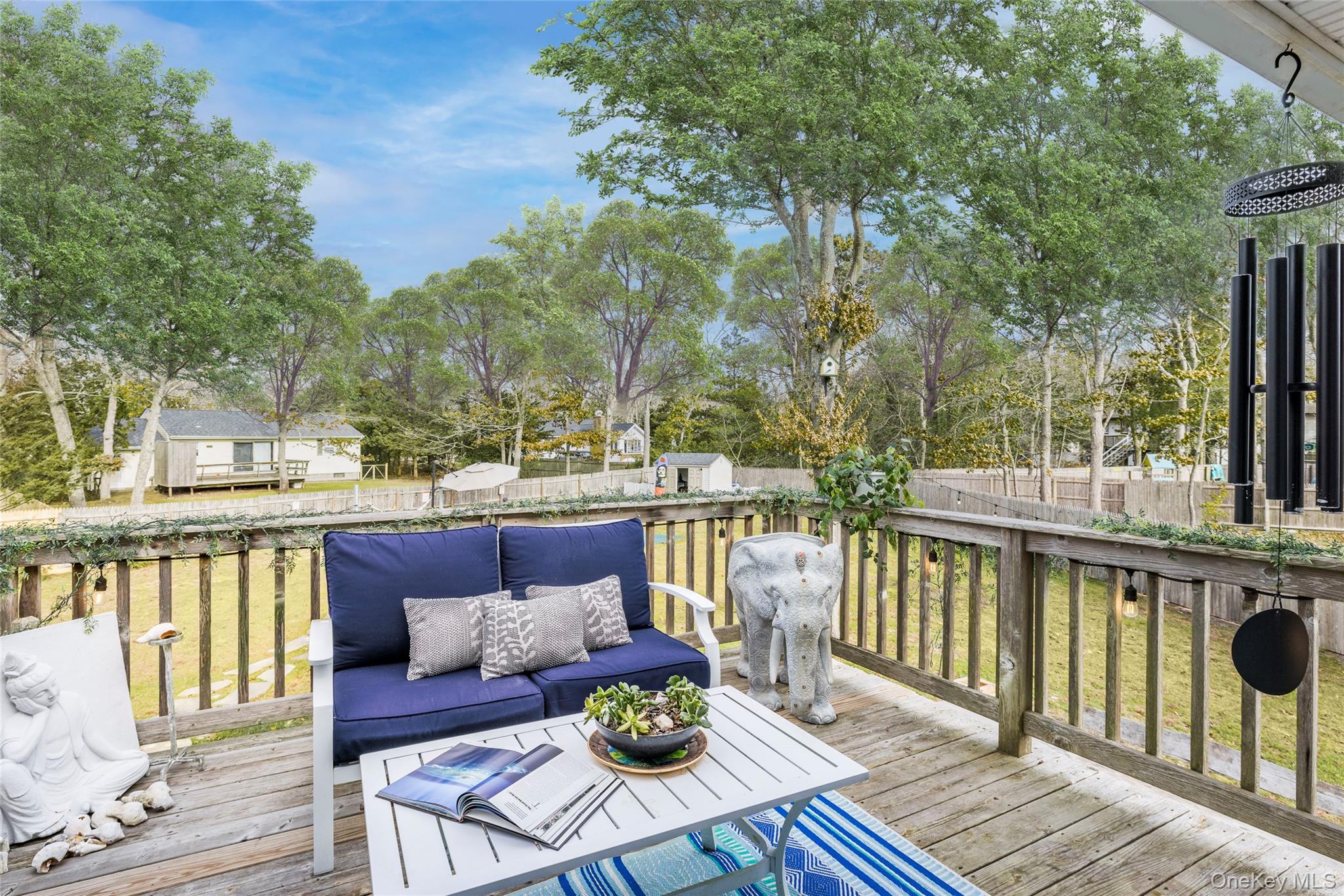 8 Westerly Court Hampton Bays, NY 11946 - Photo 12 of 26 a view of a balcony with wooden floor and outdoor seating