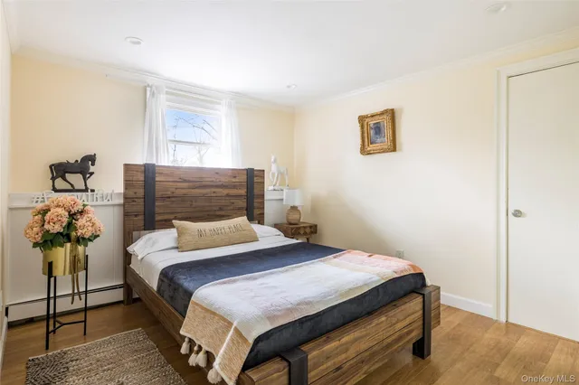 a bedroom with a bed and potted plant