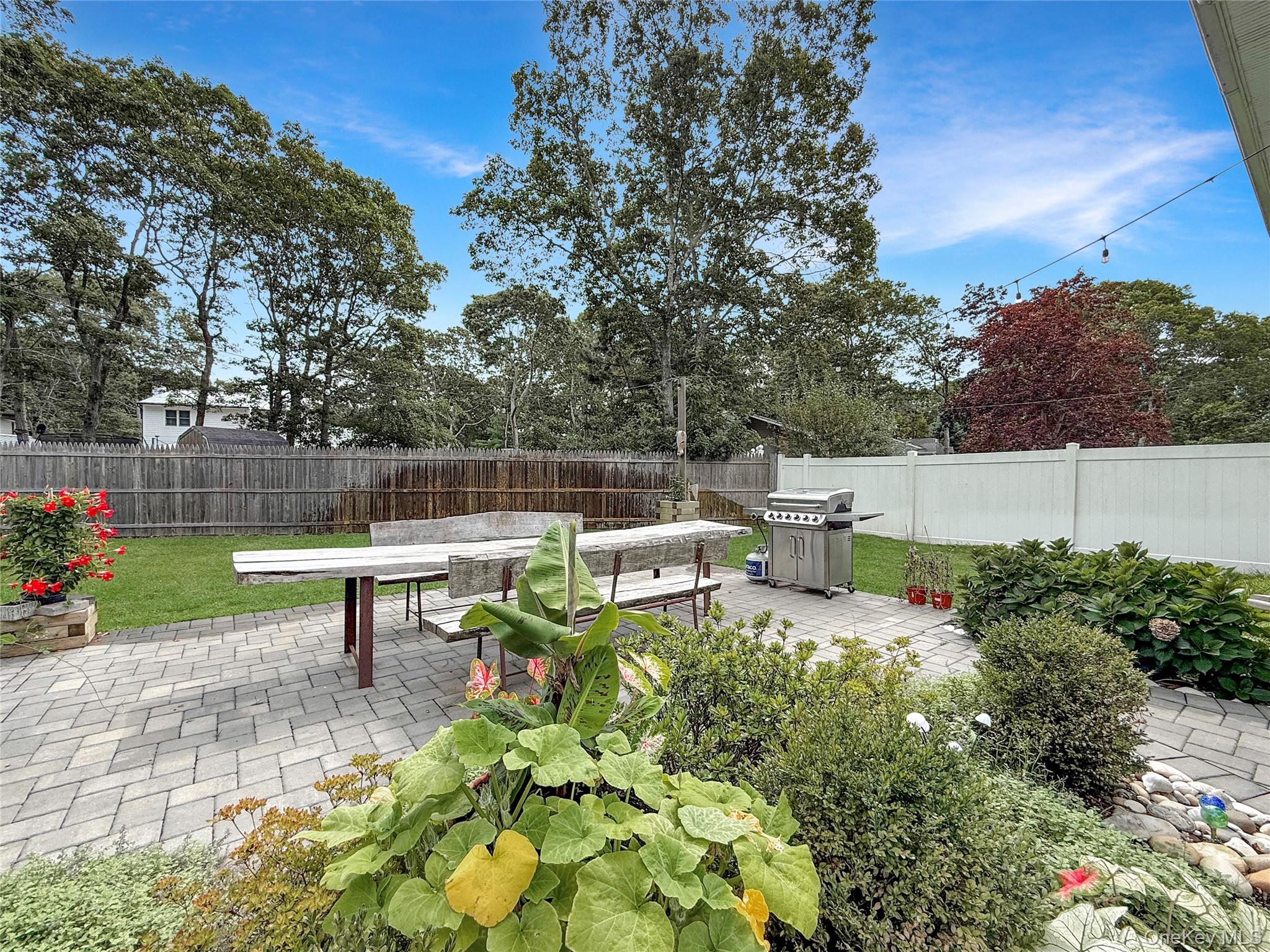 8 Westerly Court Hampton Bays, NY 11946 - Photo 2 of 26 a view of a bench in the garden