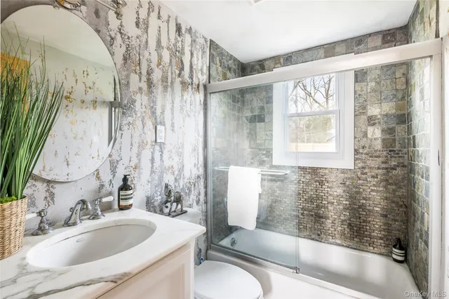 a bathroom with a sink and a large mirror