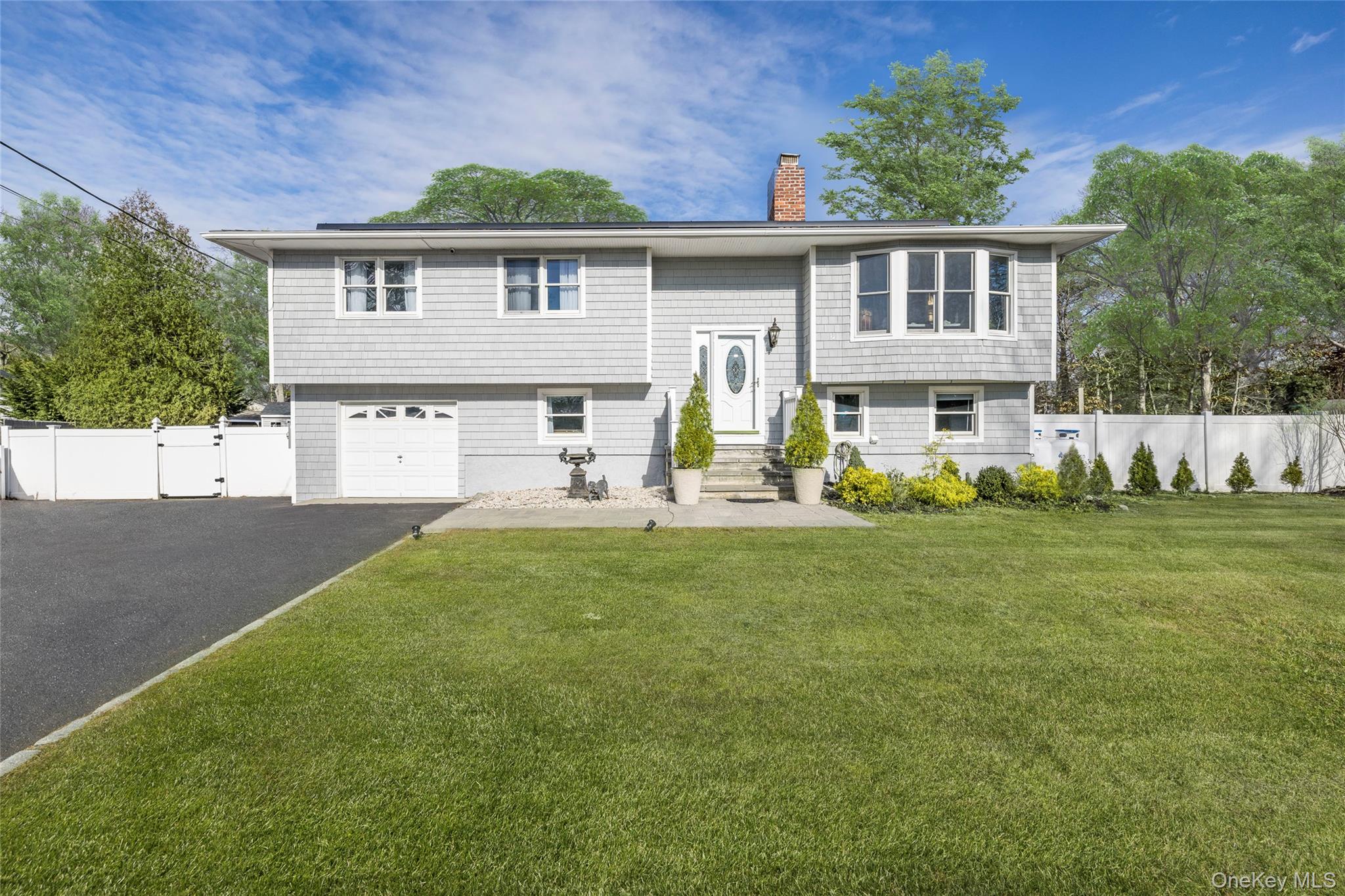 8 Westerly Court Hampton Bays, NY 11946 - Photo 25 of 26 a front view of a house with a yard
