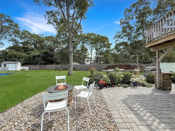 a view of a chair and table on the garden