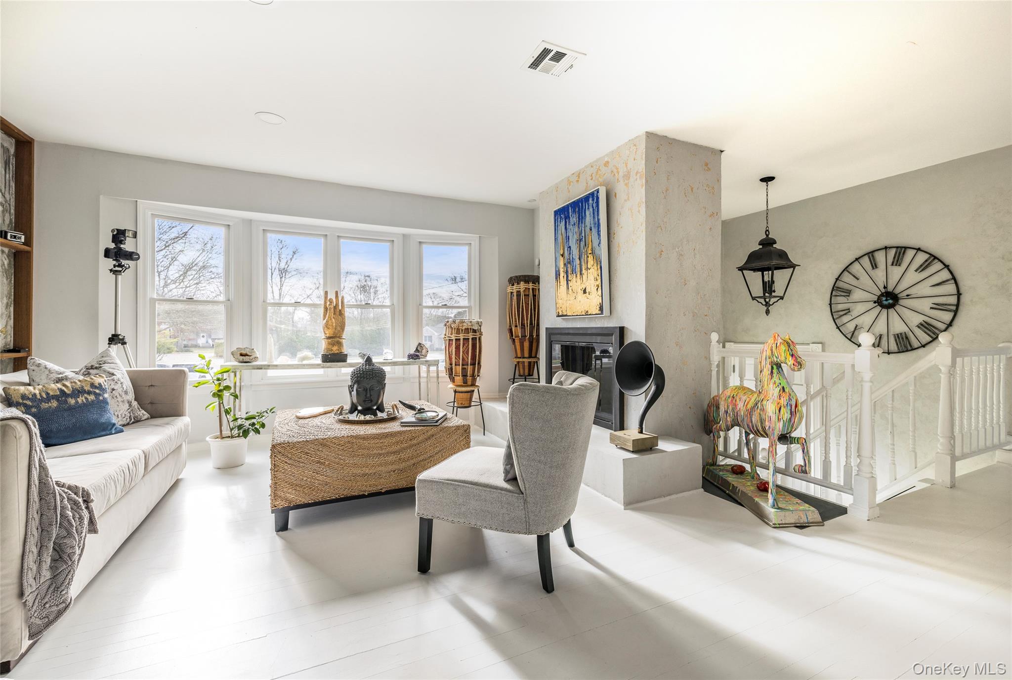 8 Westerly Court Hampton Bays, NY 11946 - Photo 8 of 26 a living room with furniture a flat screen tv and a large window