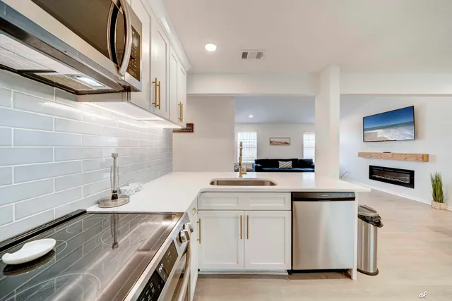 a kitchen with a refrigerator and a stove