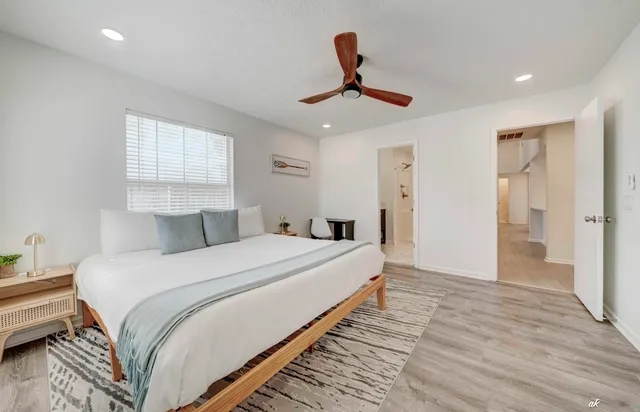 a bedroom with a bed and wooden floor