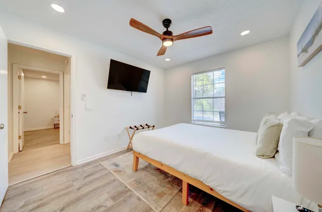 a bedroom with a bed and a flat screen tv