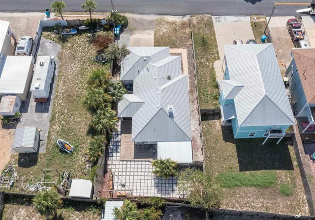a view of a house with a yard and large tree