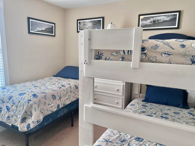 a bedroom with a bed and painting on the wall