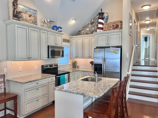 a kitchen with a stove a sink and a refrigerator