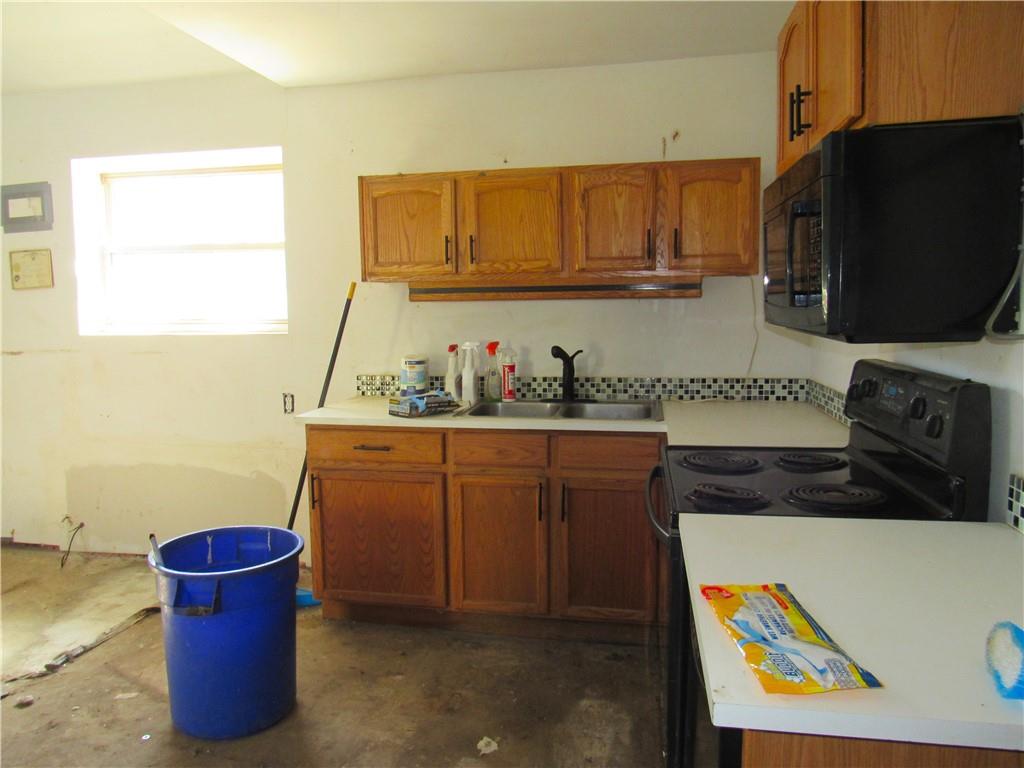 278 Chipmunk Road Evans City, PA 16033 - Photo 7 of 15 a kitchen with stainless steel appliances a stove a microwave a sink and cabinets