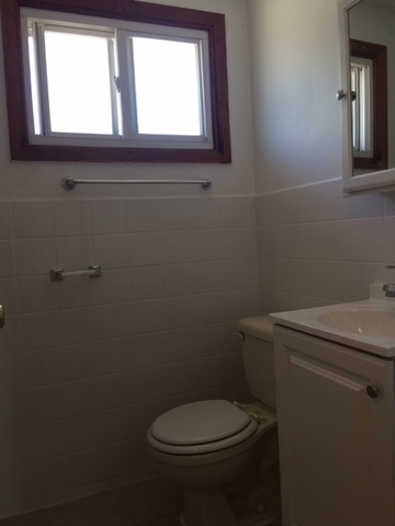 10071 Frontage Road, Unit G Skokie, IL 60077 - Photo 15 of 22 a bathroom with a toilet window and vanity