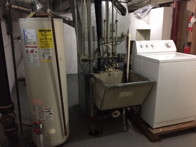 10071 Frontage Road, Unit G Skokie, IL 60077 - Photo 19 of 22 a room with water heater and refrigerator