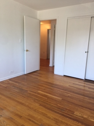 10071 Frontage Road, Unit G Skokie, IL 60077 - Photo 4 of 22 a view of an empty room with wooden floor
