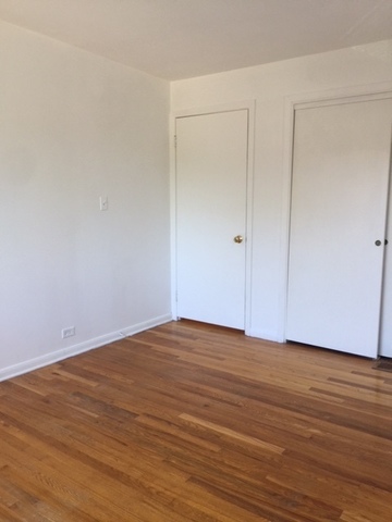 10071 Frontage Road, Unit G Skokie, IL 60077 - Photo 6 of 22 a view of an empty room with wooden floor