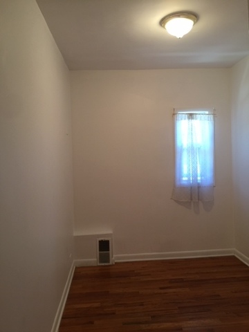 10071 Frontage Road, Unit G Skokie, IL 60077 - Photo 9 of 22 an empty room with wooden floor and windows