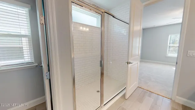 a bathroom with a glass shower door