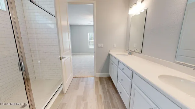 a bathroom with a double vanity sink and a mirror