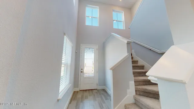 a view of entryway and hall with wooden floor