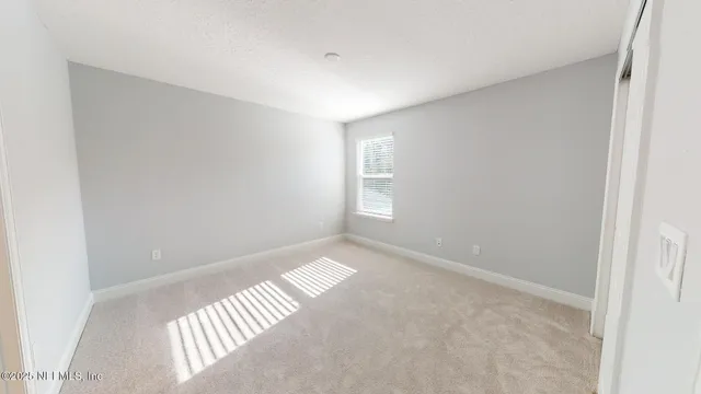 a view of an empty room and a window