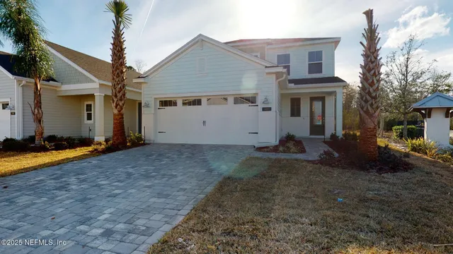 a view of a house with backyard and garden