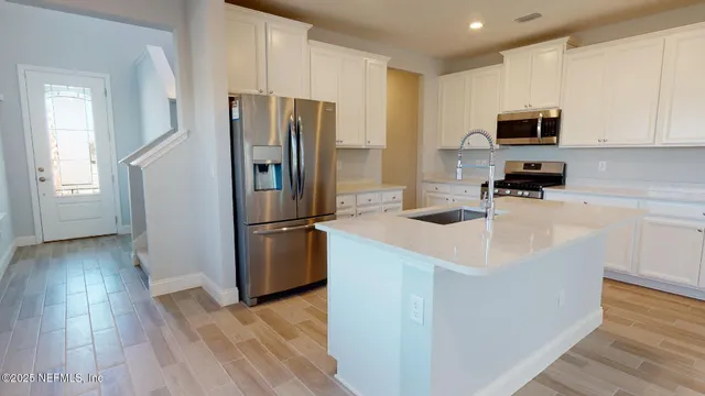 a kitchen with wooden cabinets and stainless steel appliances