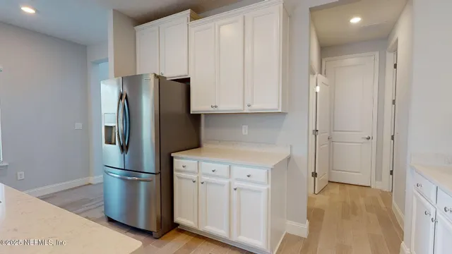 a kitchen with stainless steel appliances a refrigerator and a stove top oven
