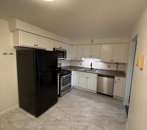 a kitchen with a sink stove and refrigerator