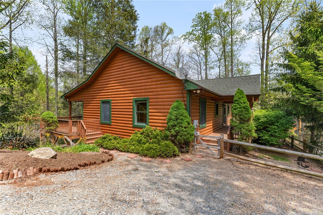 148 Woodby Ridge Road Vilas, NC 28692 - Photo 1 of 33 a front view of a house with garden