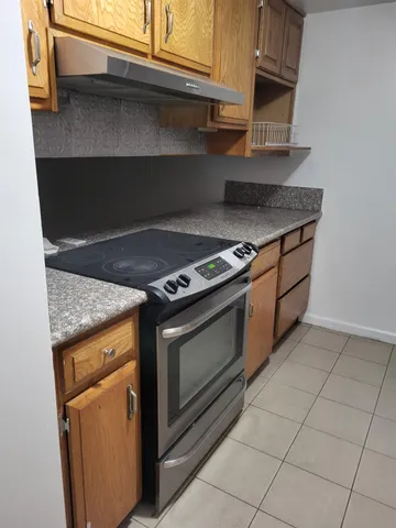 a stove top oven sitting inside of a kitchen