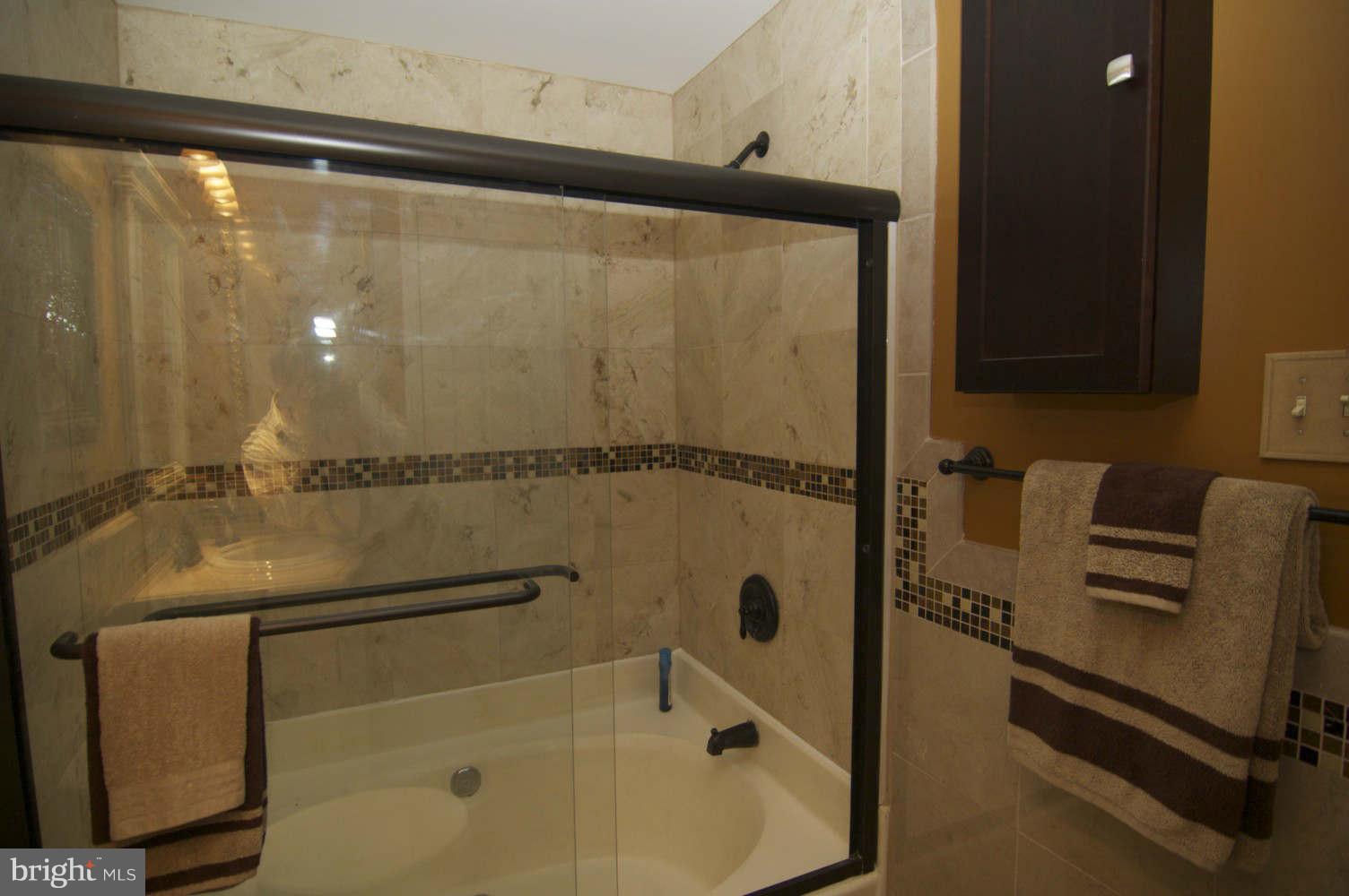 934 Pointer Ridge Drive Gaithersburg, MD 20878 - Photo 18 of 30 Redone rubbed-bronze fittings complement new tile