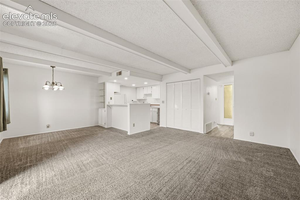 1018 Fontmore Road, Unit A Colorado Springs, CO 80904 - Photo 10 of 28 a view of empty room with a kitchen