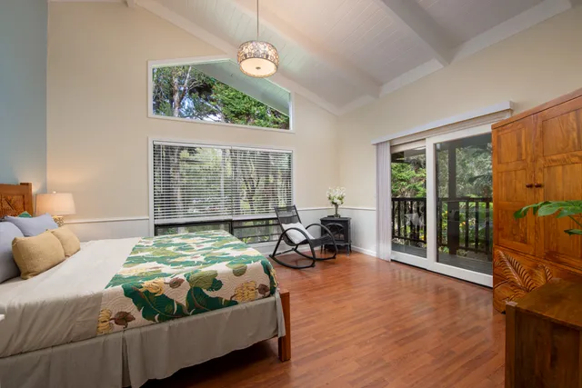 a bedroom with bed and glass window