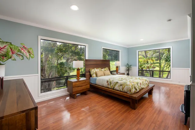 a bedroom with a bed and large window