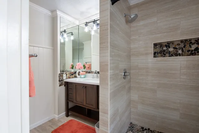 a bathroom with a sink and mirror
