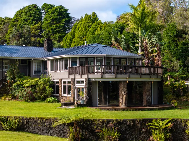 a view of a house with swimming pool and a yard