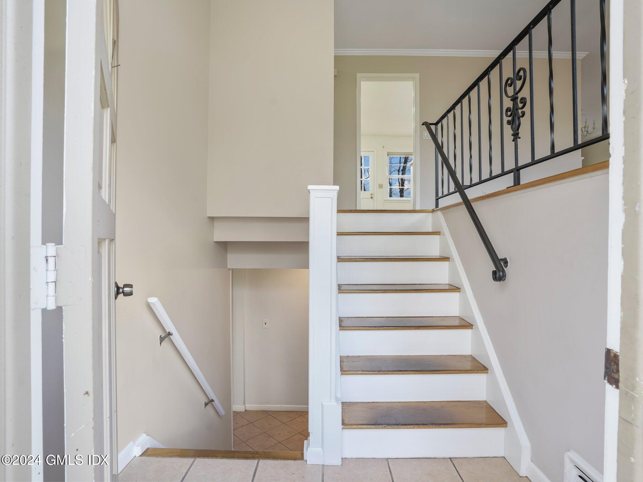 59 Lancer Road Riverside, CT 06878 - Photo 2 of 13 a view of staircase with wooden floor and white walls