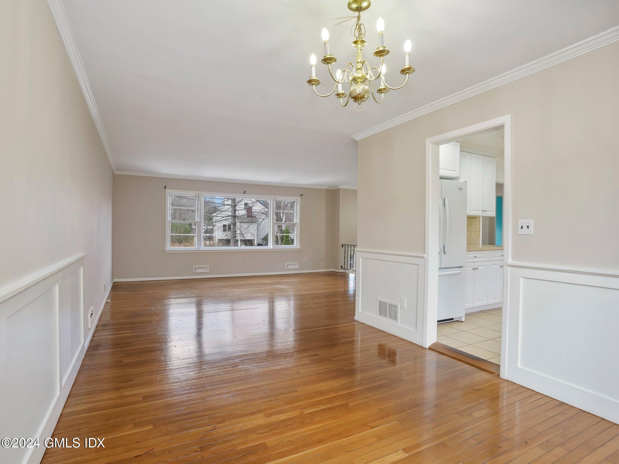 59 Lancer Road Riverside, CT 06878 - Photo 5 of 13 wooden floor in an empty room with a window