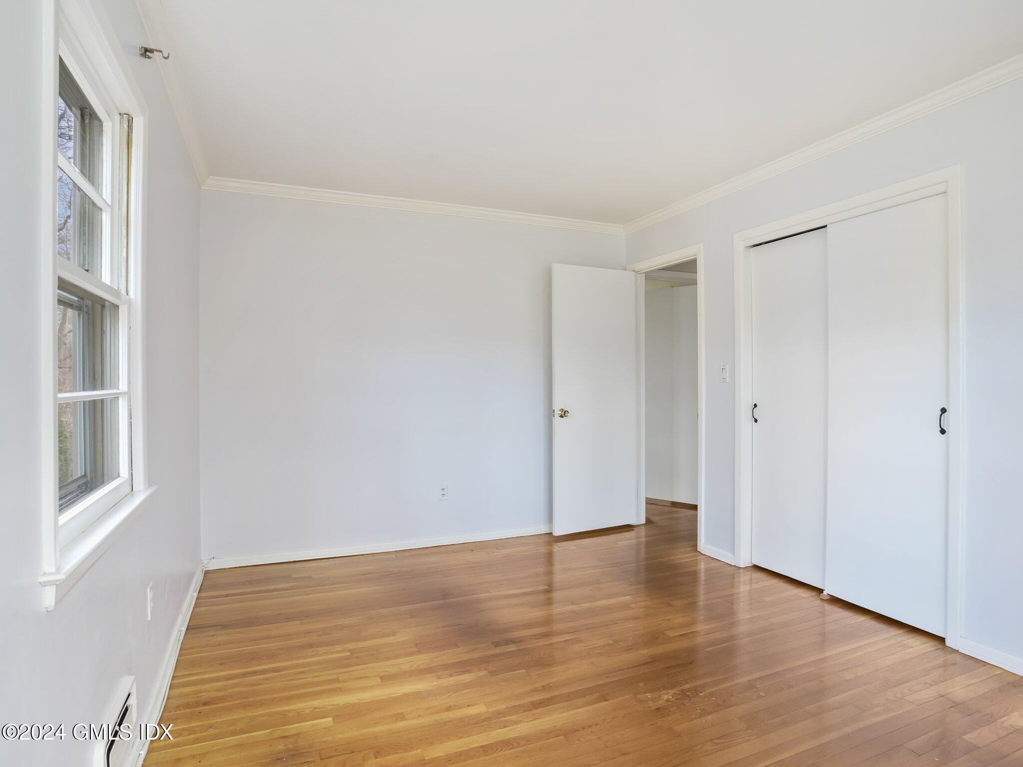 59 Lancer Road Riverside, CT 06878 - Photo 9 of 13 a view of an empty room with wooden floor and a window