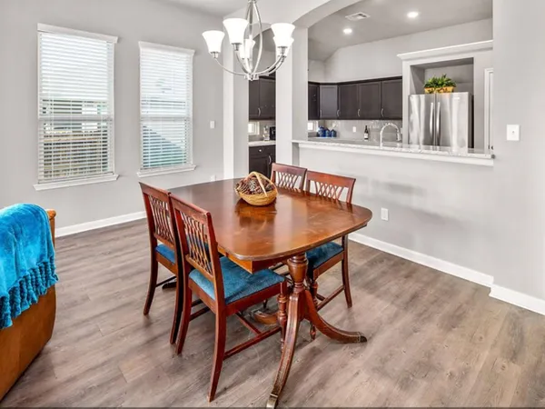 a view of a dining room with furniture and a flat screen tv