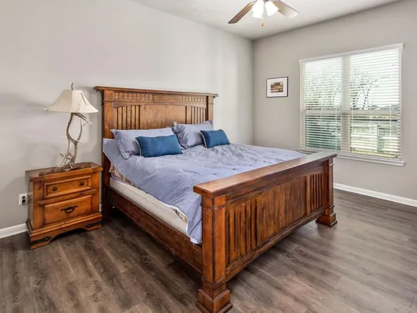 a bed sitting in a bedroom next to a window