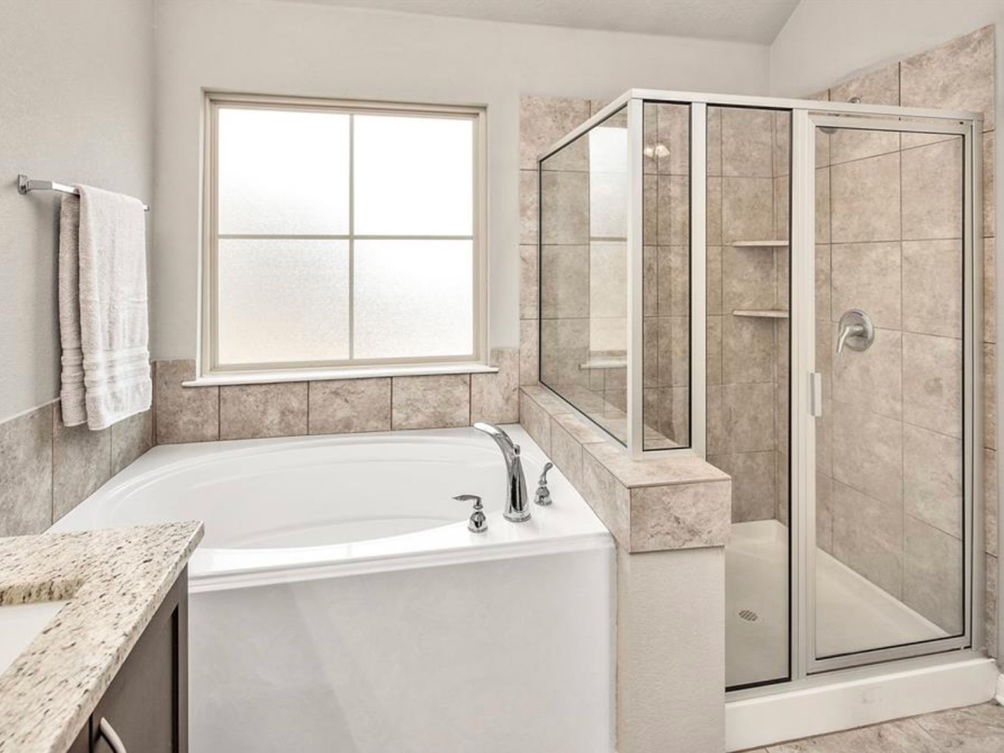 2025 Jester Trail Bryan, TX 77807 - Photo 18 of 24 a bathroom with a granite countertop bathtub and a sink
