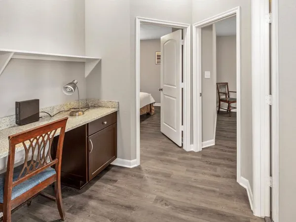 a view of a hallway with wooden floor and entryway