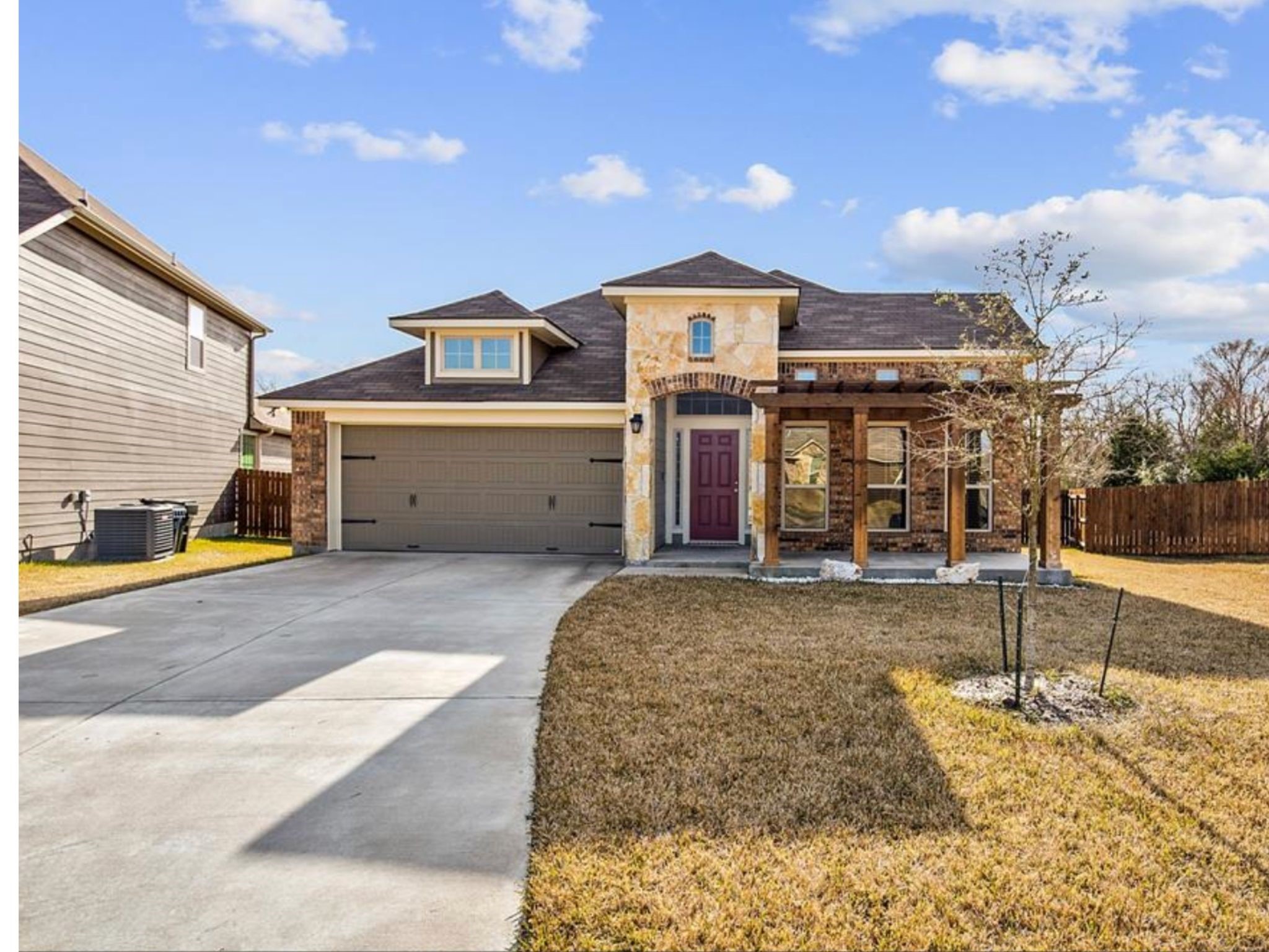 2025 Jester Trail Bryan, TX 77807 - Photo 2 of 24 a front view of a house with a yard