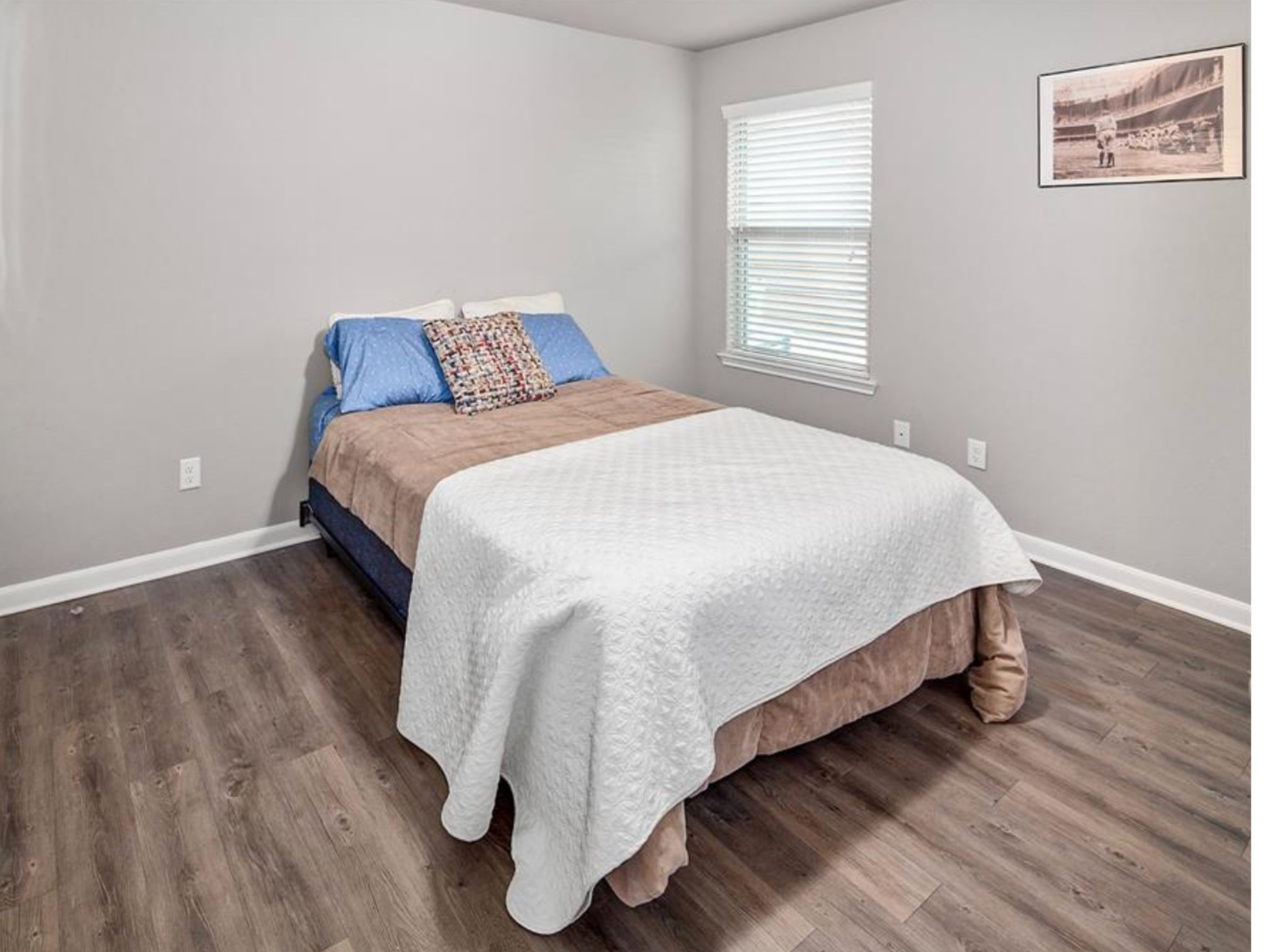 2025 Jester Trail Bryan, TX 77807 - Photo 22 of 24 a bedroom with a bed and wooden floor