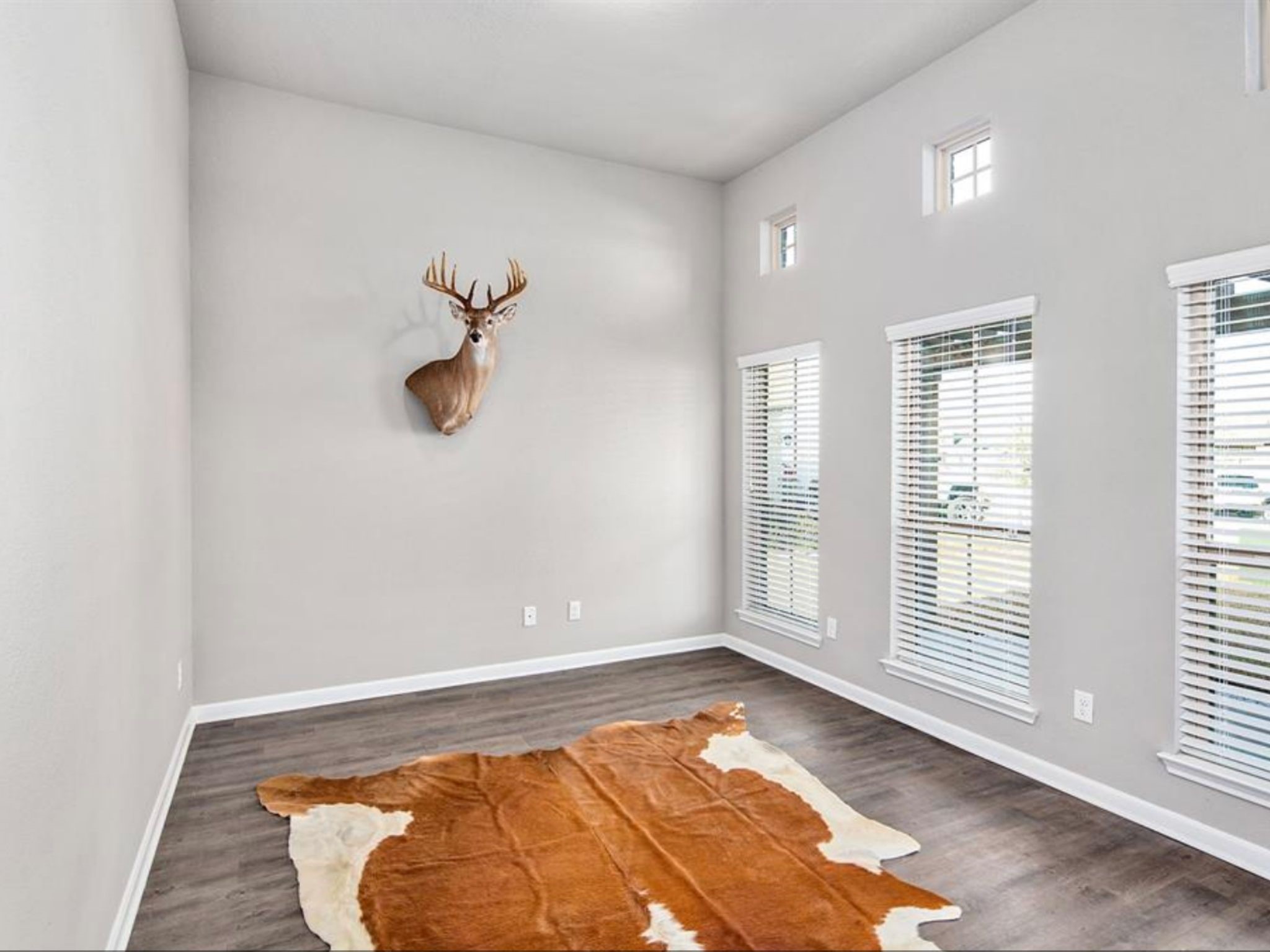 2025 Jester Trail Bryan, TX 77807 - Photo 4 of 24 a view of empty room with wooden floor and fan