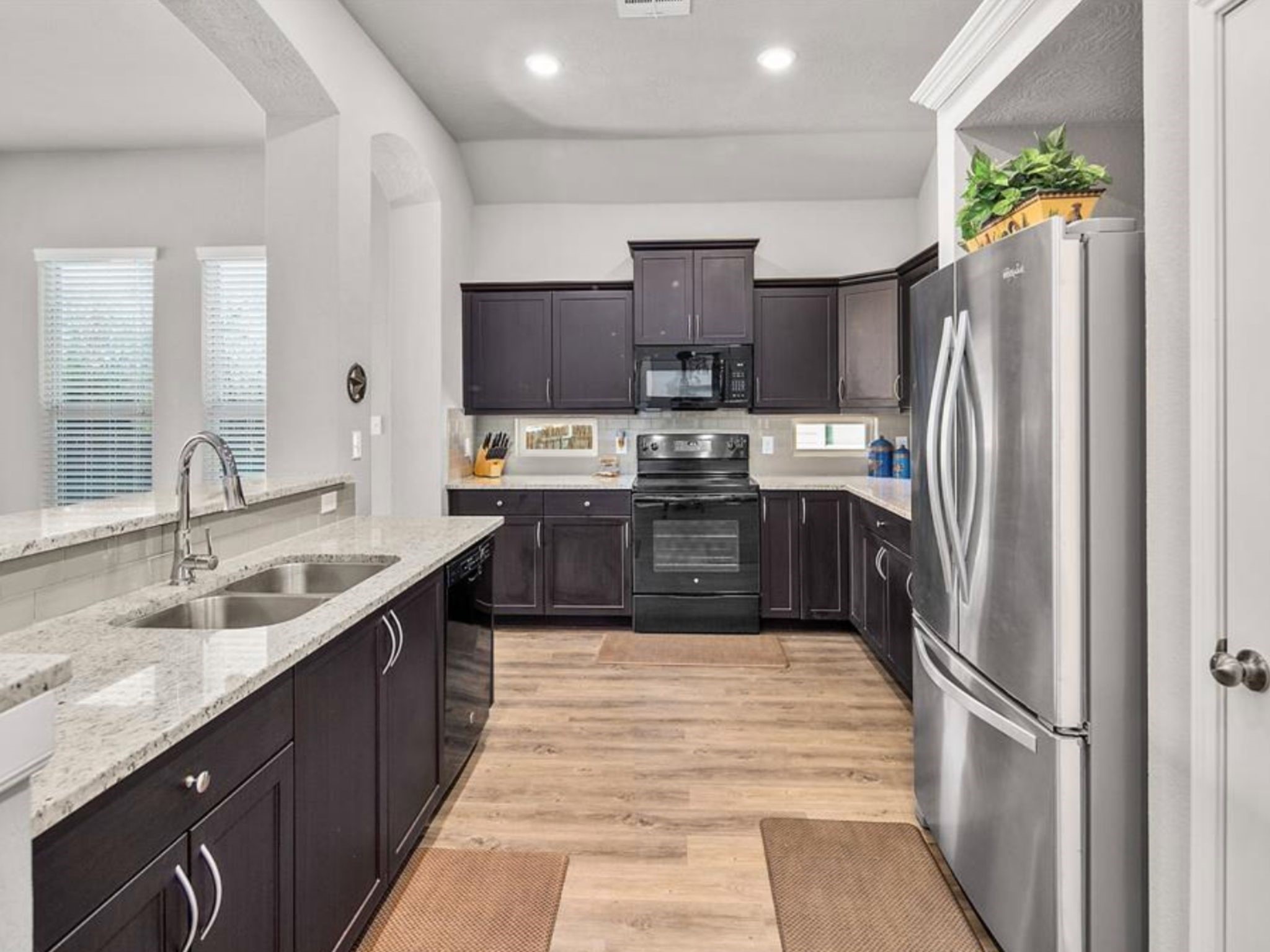 2025 Jester Trail Bryan, TX 77807 - Photo 6 of 24 a large kitchen with stainless steel appliances granite countertop a sink counter space and cabinets
