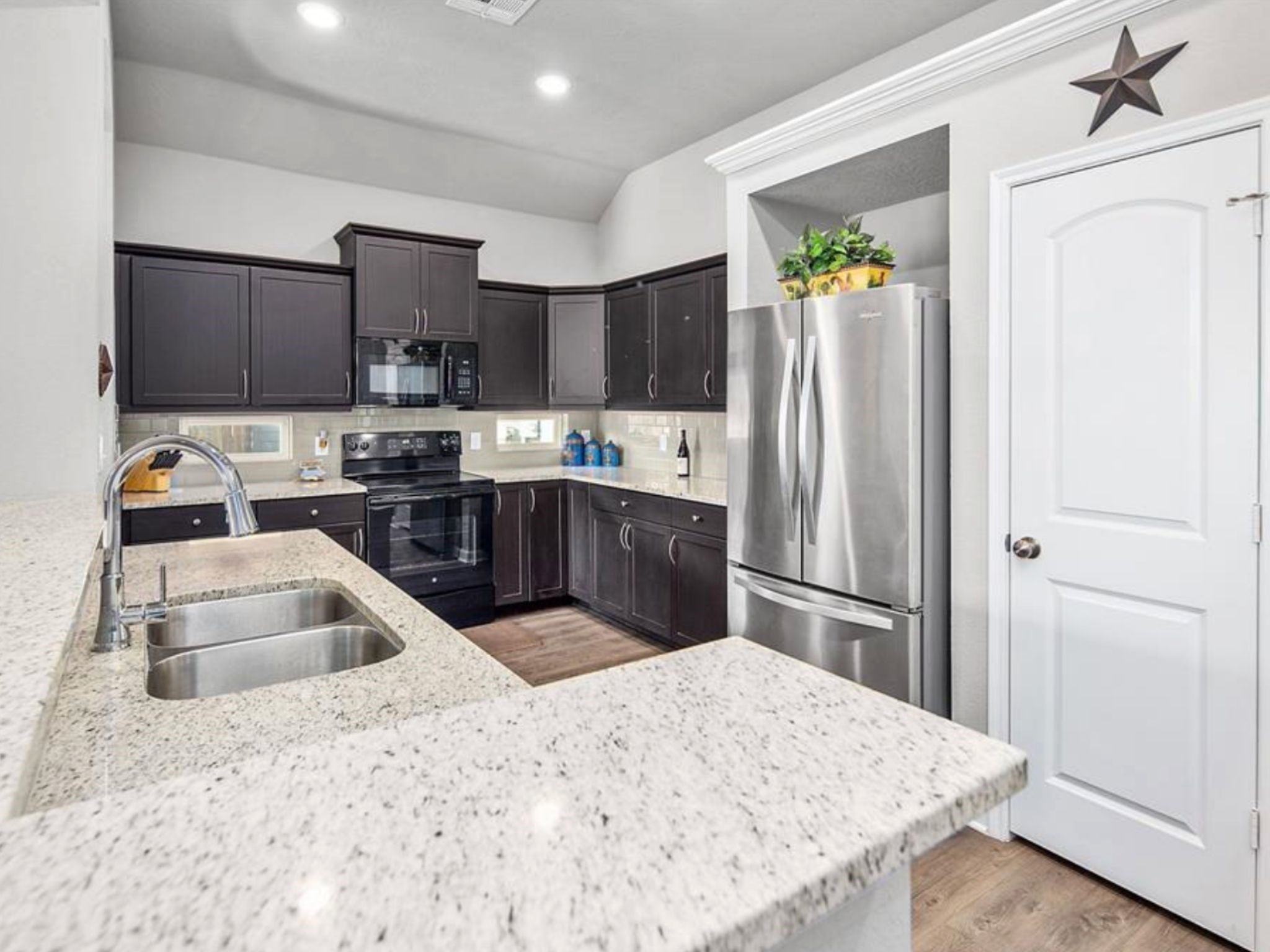 2025 Jester Trail Bryan, TX 77807 - Photo 7 of 24 a kitchen with a refrigerator sink and cabinets
