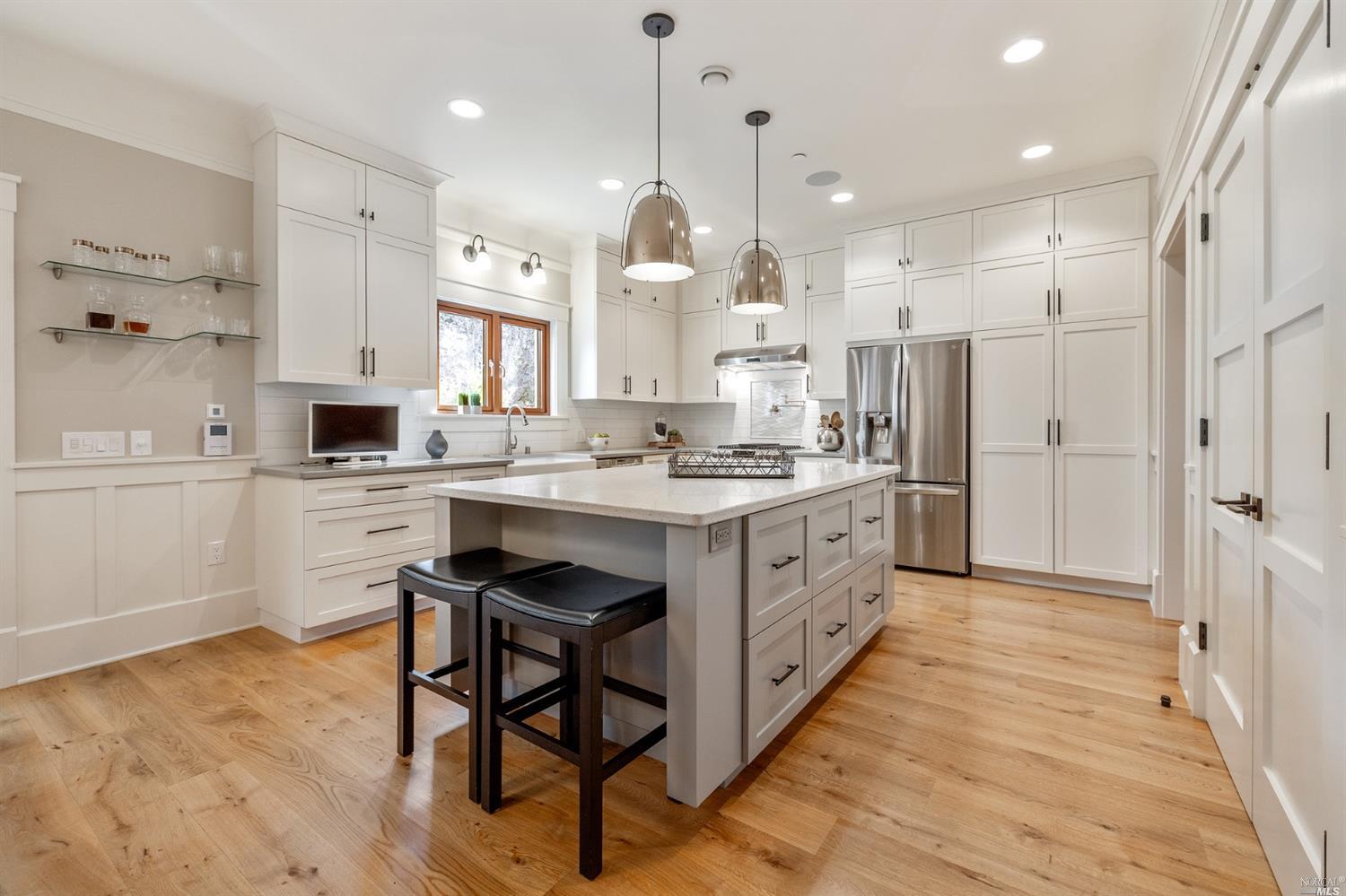 348 Patten Street Sonoma, CA 95476 - Photo 1 of 1 a large kitchen with kitchen island white cabinets and stainless steel appliances