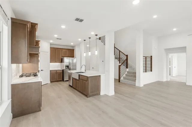 a kitchen with a sink stove and cabinets