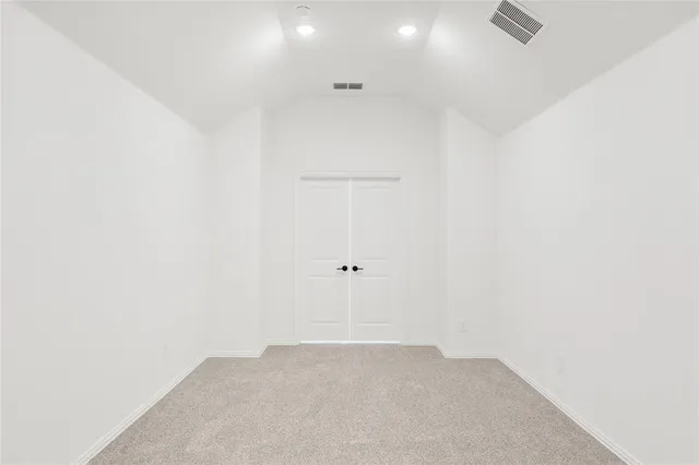an empty room with a window and a ceiling fan